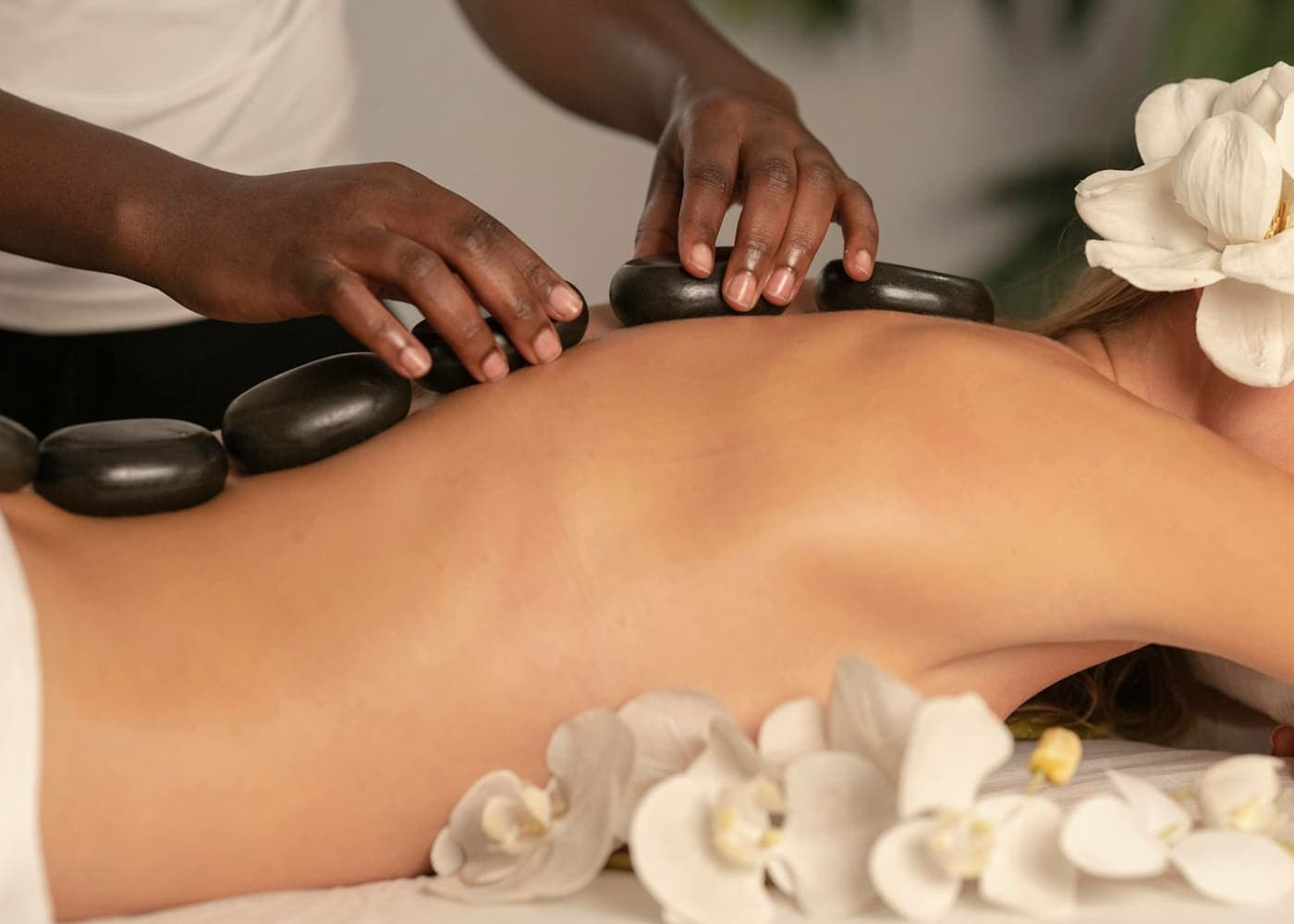 Serene treatment room with a dressed massage bed and soft lighting