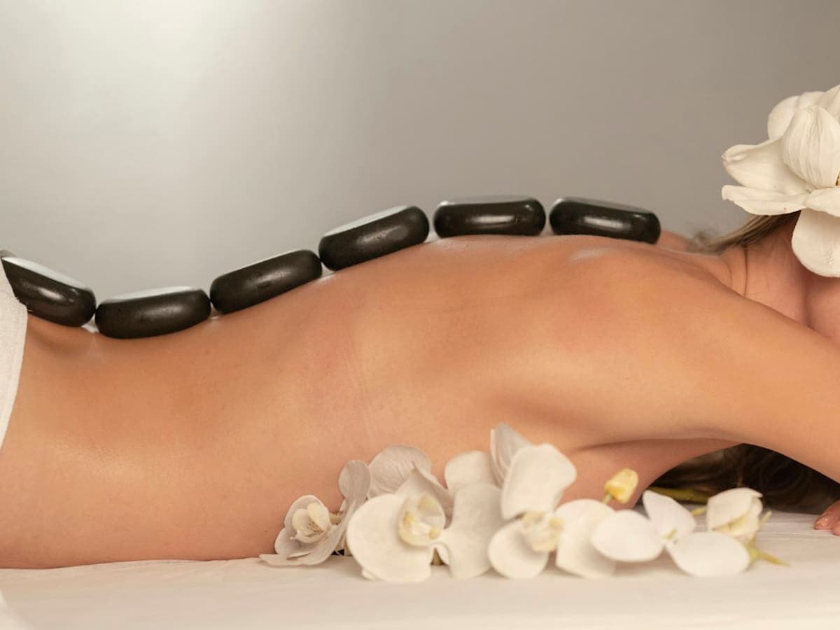 Two side-by-side treatment beds prepared for a couples' wellness experience