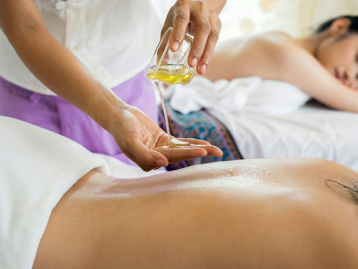 Therapist performing a gentle relaxation massage on a guest's shoulders